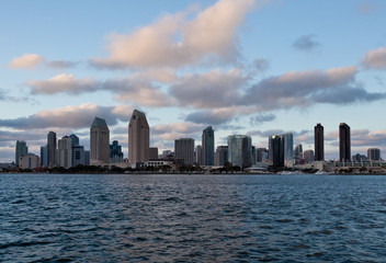 Fototapeta na wymiar Orange clouds reflect light from San Diego Skyline