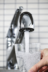 Filling glass of tap water © Elenathewise