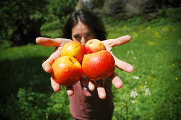 Smiling girl holding apples