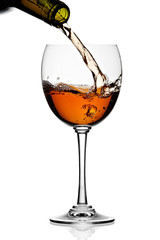 White wine poured in a glass isolated on a white background