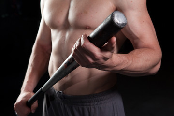 Shirtless guy holding a baseball bat