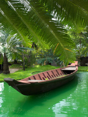 Naklejka na ściany i meble Boat and the palm trees