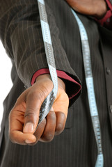 Black business man wearing a measuring tape