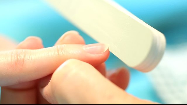 Nail care manicurewith emery board, macro view