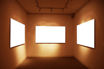 empty frames in a room against a white wall .