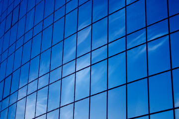 Background. Blue windows and sky reflections. Modern building