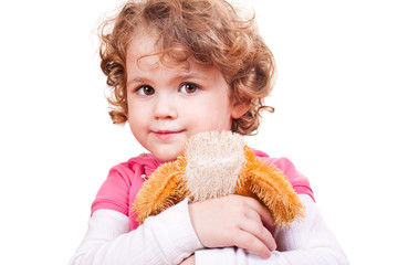 little girl hugging toy dog