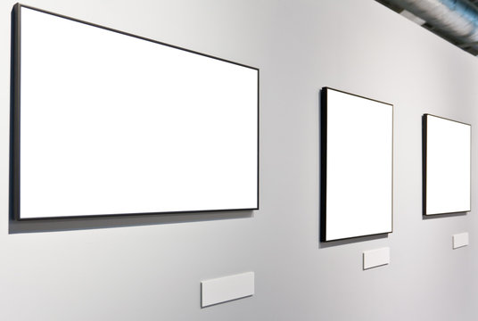 White wall in museum with empty frames