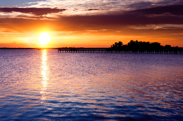 Dramatic sunrise over river pier. Indian river, Florida, USA - 23449426