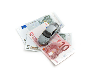 Toy car on money.  Isolated on white background
