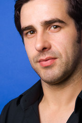 Fototapeta premium Young casual atractive man portrait, on a blue background