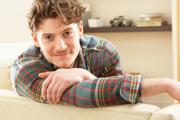 Man Relaxing On Sofa At Home