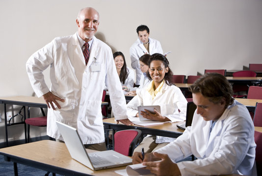 Professor with medical students in classroom