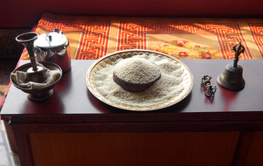 rice bowl, tibetan bell and dorje in buddhist temple