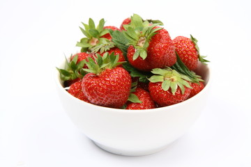 Strawberries in a bowl on white background
