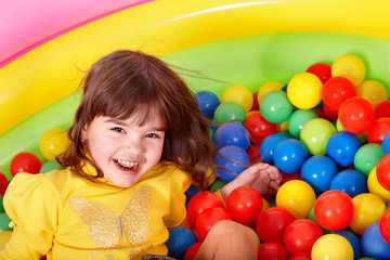 Fototapeta na wymiar Happy child in group colourful ball.