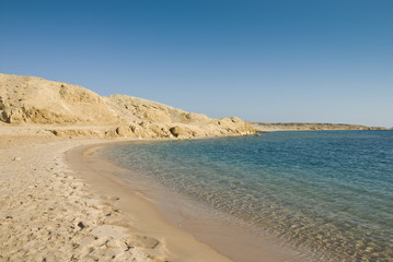 Empty sandy beach in a tropical lagoon.
