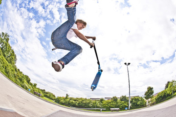 boy with scooter is going airborne