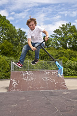 boy with scooter is going airborne