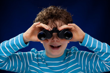 Boy looking through binoculars
