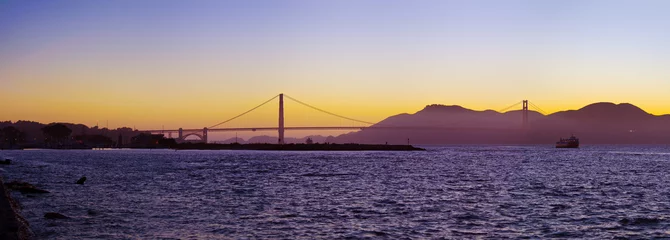 Fotobehang The Golden Gate Bridge silhouetted at sunset © sfmthd