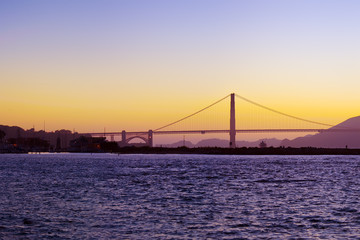 The Golden Gate Bridge silhouetted at sunset