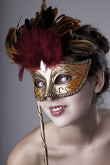 Obraz na płótnie Canvas Beautiful girl with a carnival mask