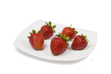 Ripe strawberry on a white plate