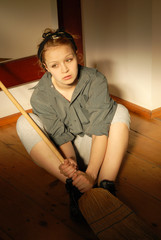 young housekeeper with a broom