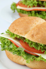 Ham and cheese sandwiches with tomatoes and lettuce