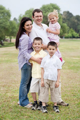 Fototapeta premium Happy family of five posing on natural background