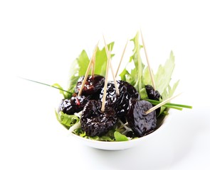 Bowl of greens and prunes