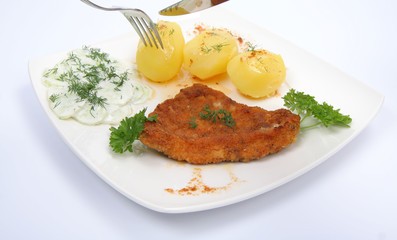 Pork chop and mashed potatoes being cut