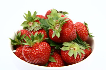 Strawberries in a bowl on white background