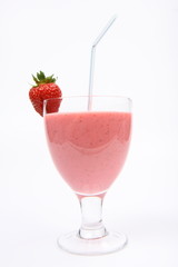 Strawberry shake in a glass with a straw and a strawberry