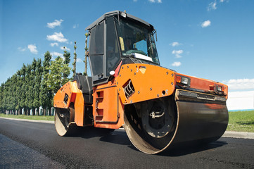 Compactor at asphalt pavement works (wide angle)