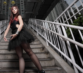 Ballerina posing on a staircase in the city