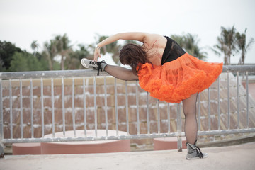 Woman stretching her leg on the rail