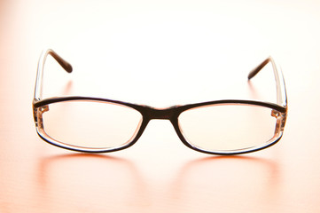 Reading glasses on the wooden table