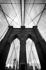 Black and white upward view of Brooklyn Bridge