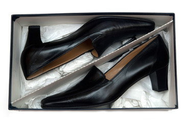 Fototapeta na wymiar black female leather shoes in the box isolated
