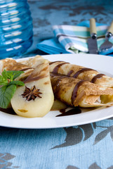 Rolled pancakes with poached pear