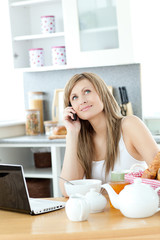 Obraz na płótnie Canvas Pensive woman having a breakfast in the kitchen