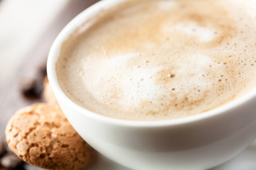 Cup of delicious coffee with milk froth