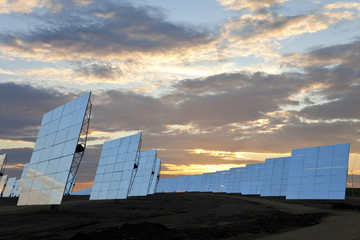 A Field of Green Energy Solar Mirror Panels at Sunset