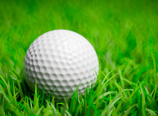 3D render of a golf ball in grass field with shallow DOF