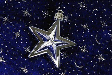 star ornament on blue sky with siver stars pattern