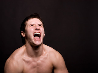 Angry man screaming in extreme rage