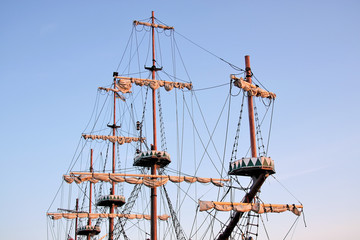 Masts against blue sky.