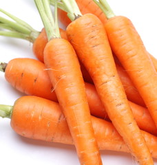 Ripe fresh carrots on a white background.